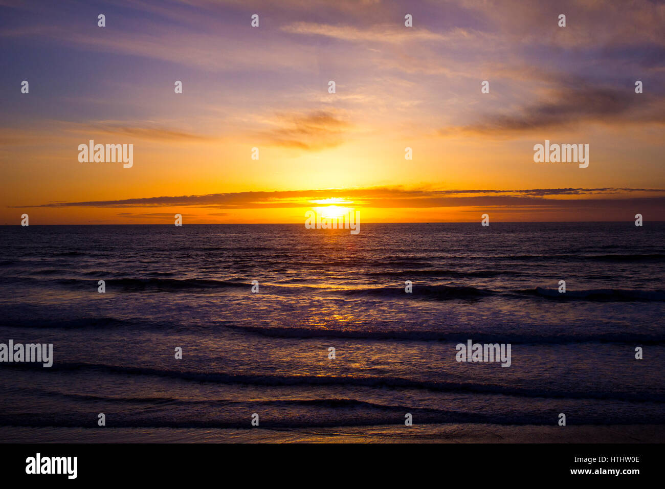 Sunset over the ocean with waves Stock Photo - Alamy
