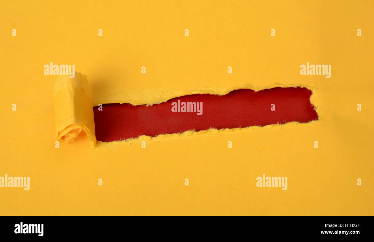 Ripped Yellow color sheet with red background Stock Photo - Alamy