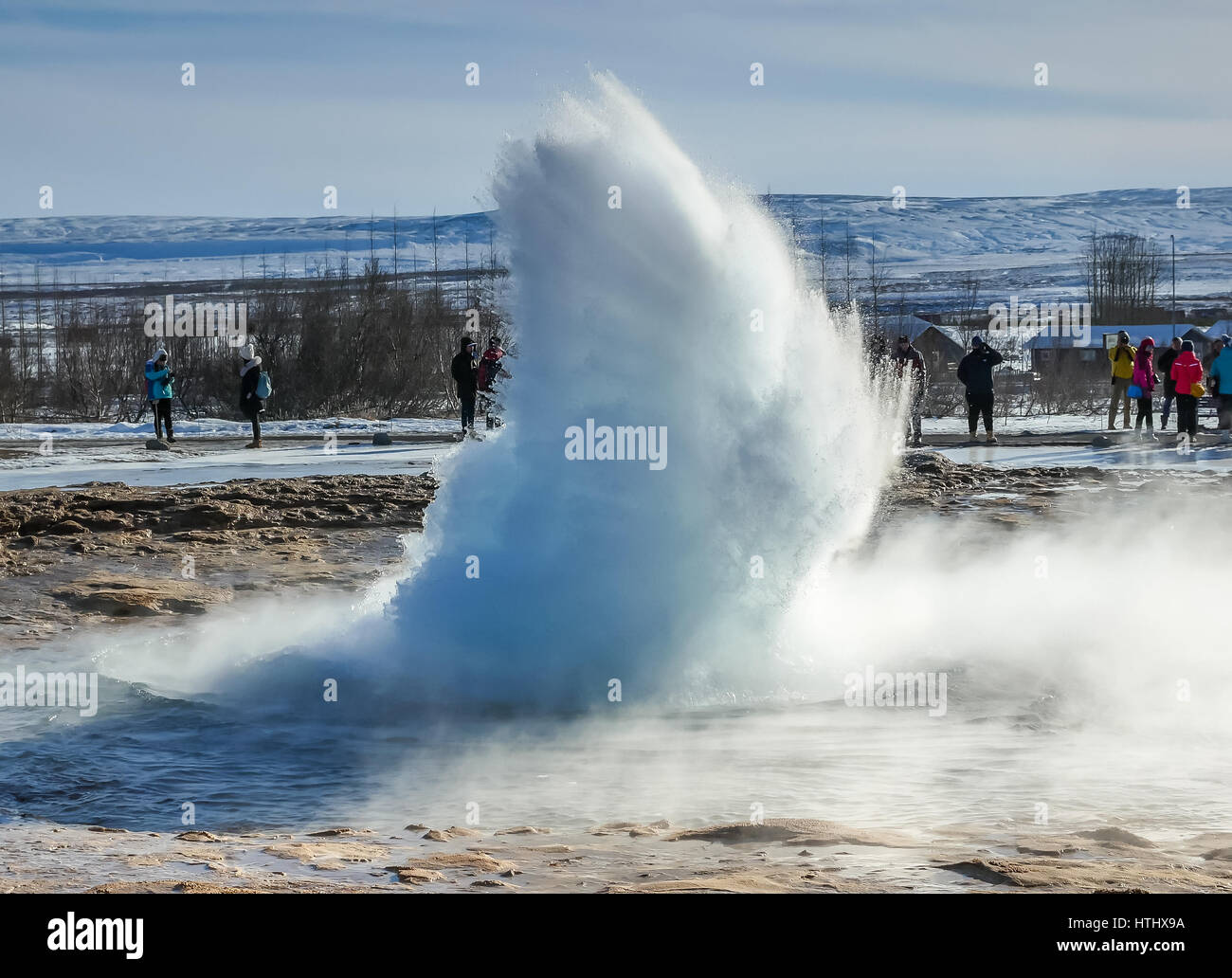 Crowd watching the moment of a geyser, or hot spring erupting, Golden Circle, Iceland Stock Photo