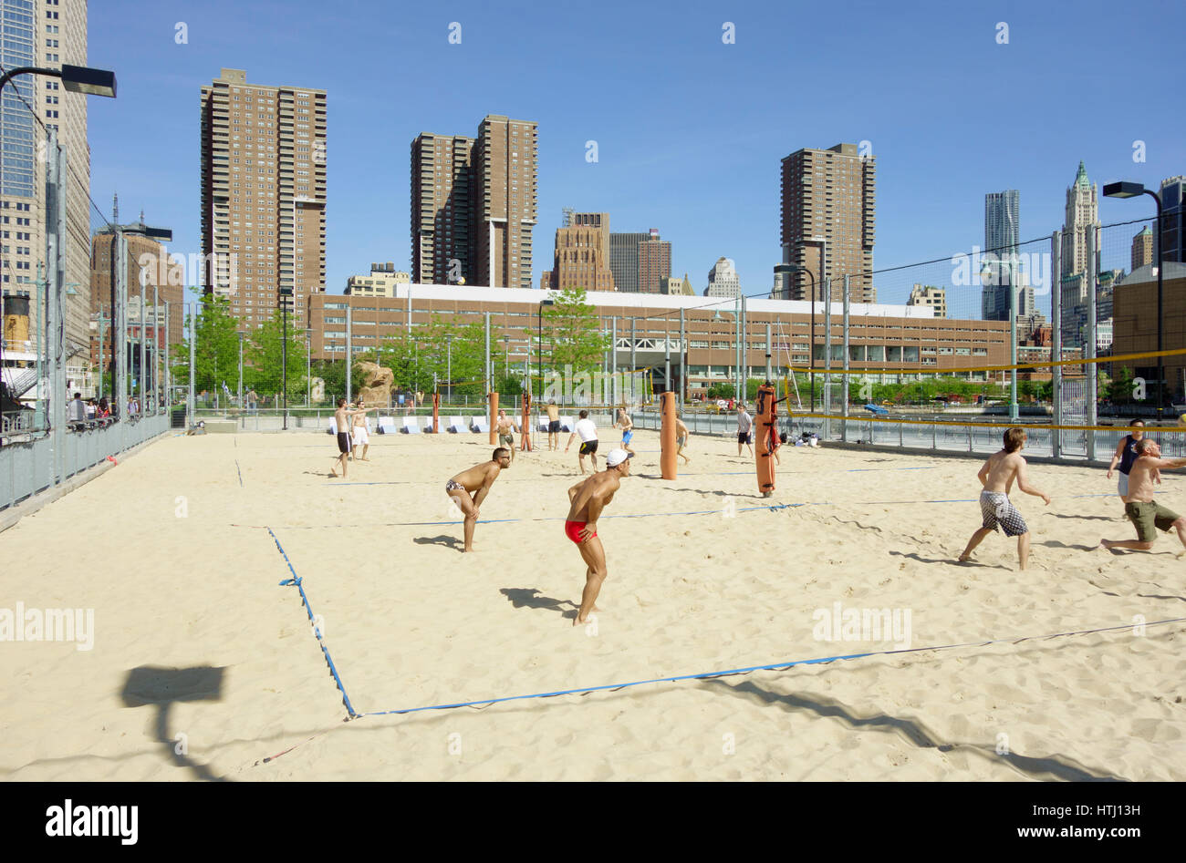 Men playing beach volleyball, Pier 25, Hudson River Park, Tribeca, NYC, USA Stock Photo