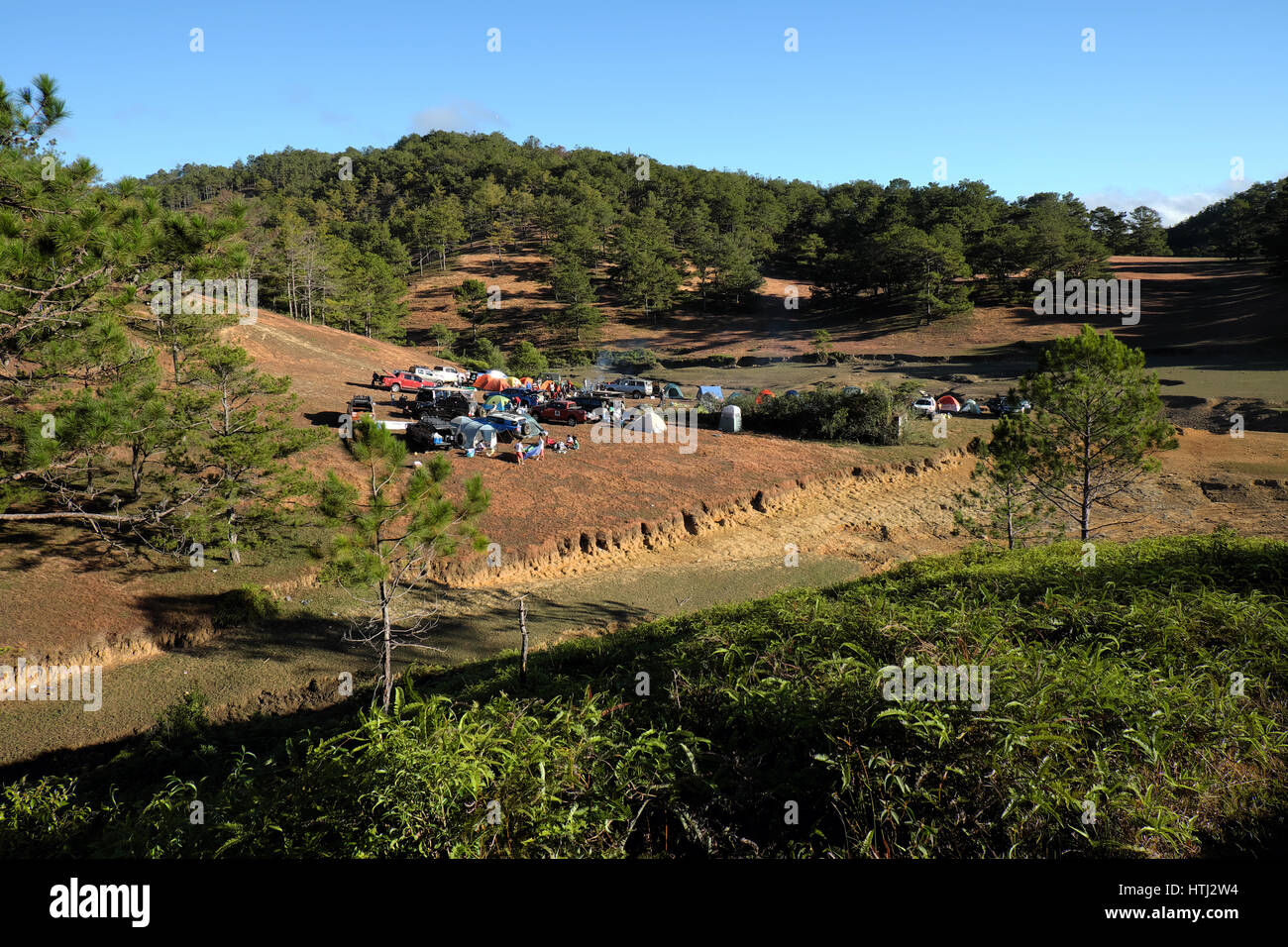 DA LAT, VIET NAM- JAN 2: Group of person  in family vacation in spring, people with 4x4 terrain car camp at pine forest, exciting experience in eco tr Stock Photo
