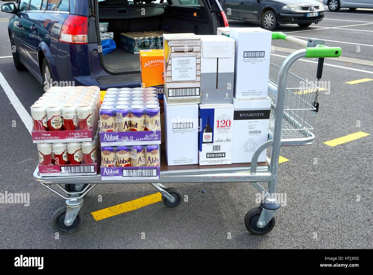 COQUELLES, PAS-DE-CALAIS, FRANCE, MAY 07 2016: Shopping trolley loaded with cheap beer and wine Stock Photo
