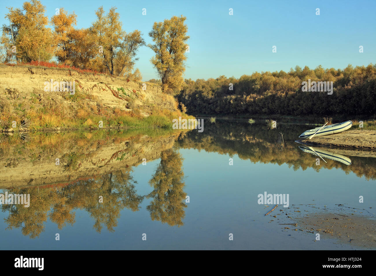 Boat on the bank of the autumn river Stock Photo - Alamy