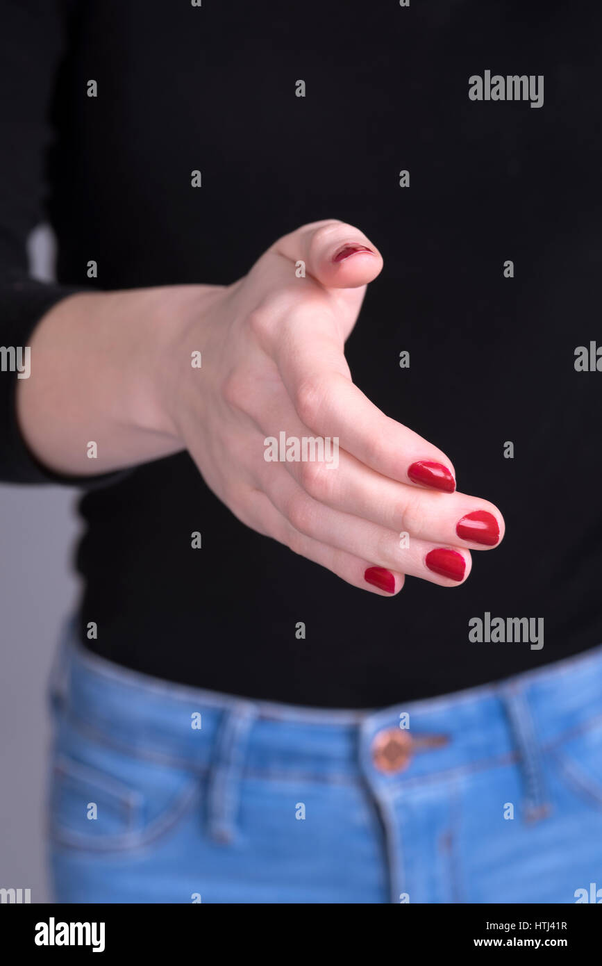 Woman's hand with painted nails in a handshake position Stock Photo - Alamy