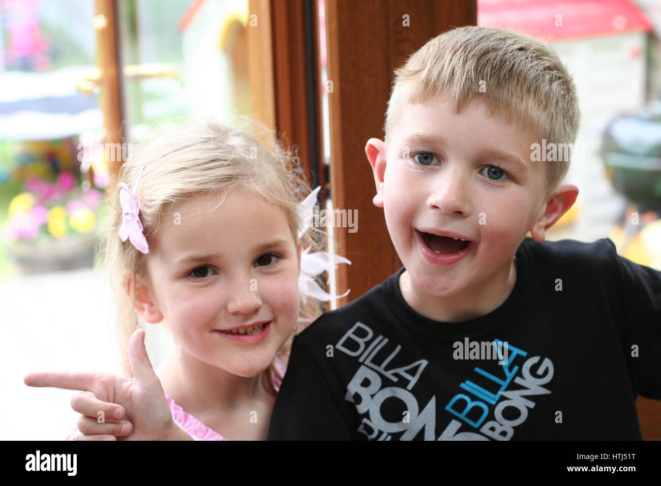 blonde boy and girl laughing, kids children messing around goofing and having fun messing together, family fun concept, happy blonde kids fun concept, Stock Photo