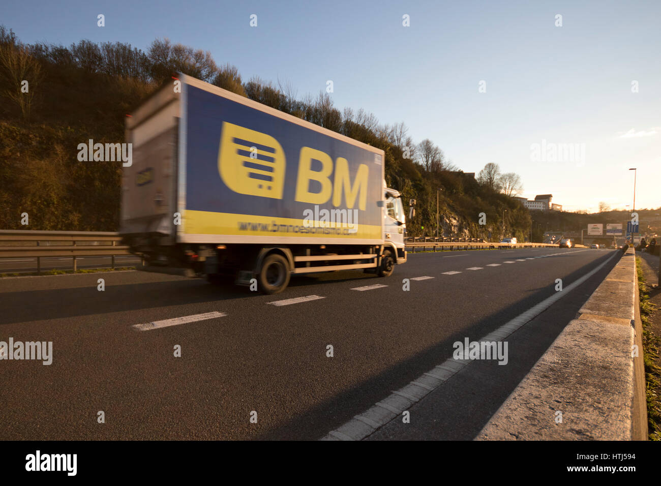 Moving BM supermarket delivery truck in a highway in Guipuzcoa (Basque country, Spain) 2017. Stock Photo