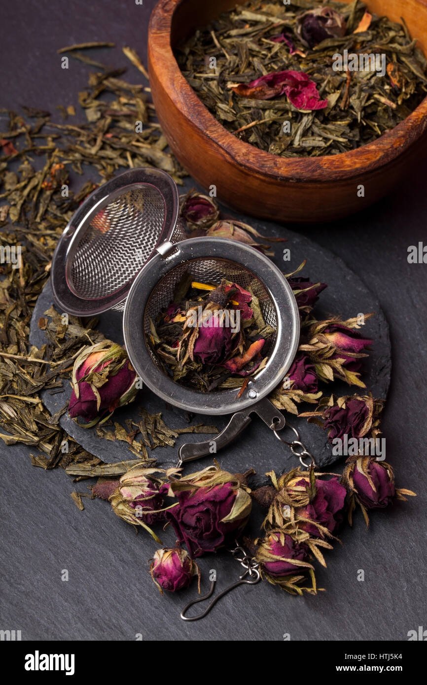 Green tea with roses blossoms Stock Photo