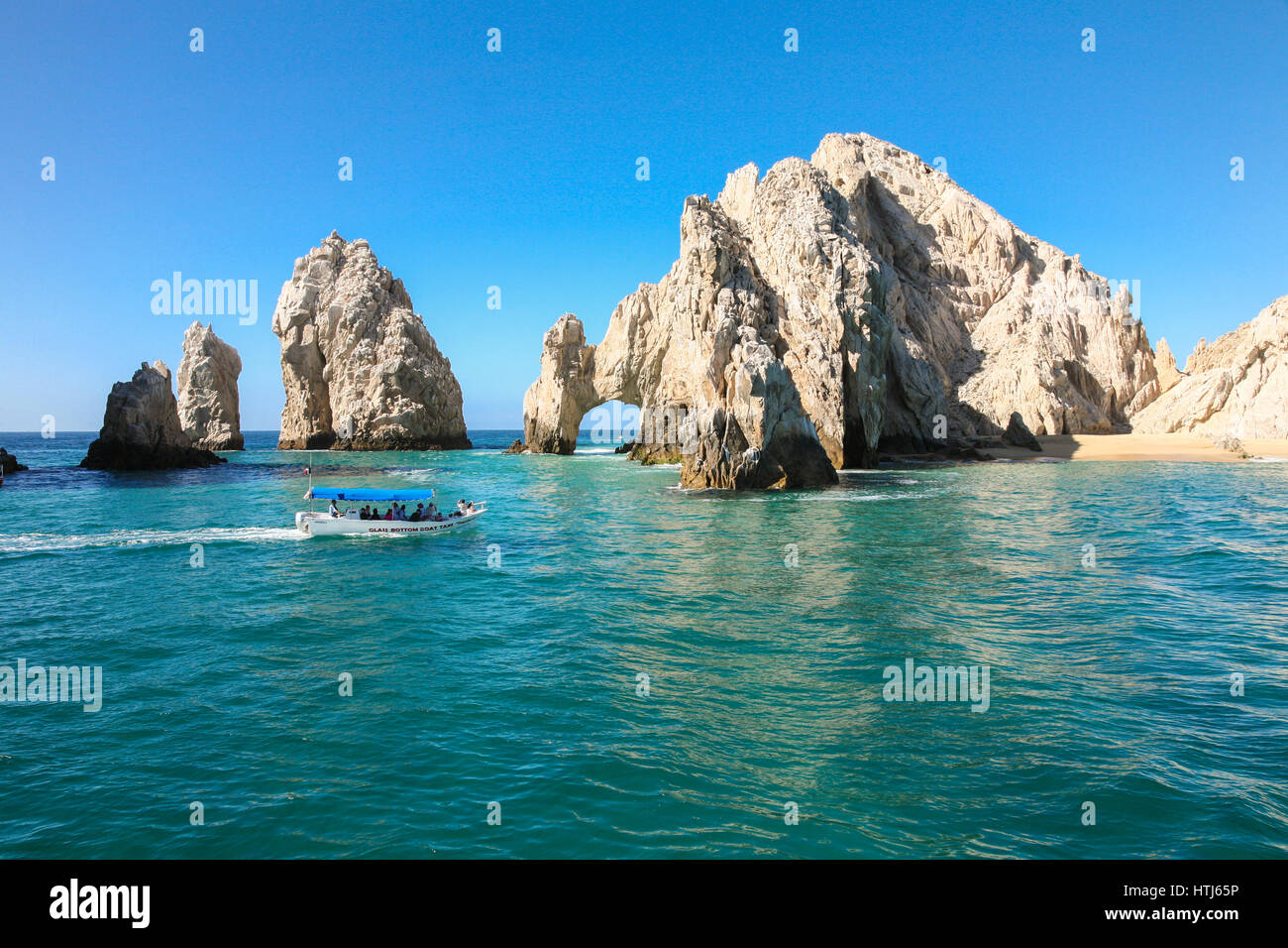 CABO SAN LUCAS, MEXICO -MARCH 20, 2012 :  Boat with tourists approaching The Arch  Cabo San Lucas, Mexico Stock Photo