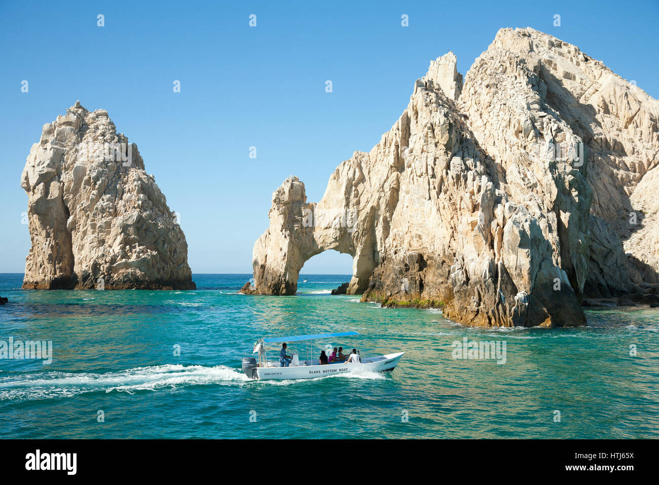 CABO SAN LUCAS, MEXICO -MARCH 20, 2012 :  Boat with tourists approaching The Arch  Cabo San Lucas, Mexico Stock Photo
