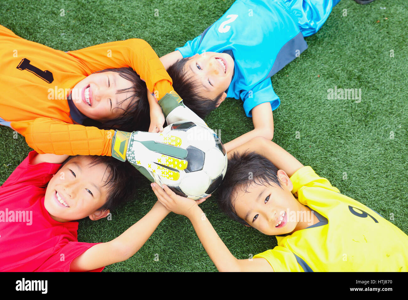 Japanese kids playing soccer Stock Photo