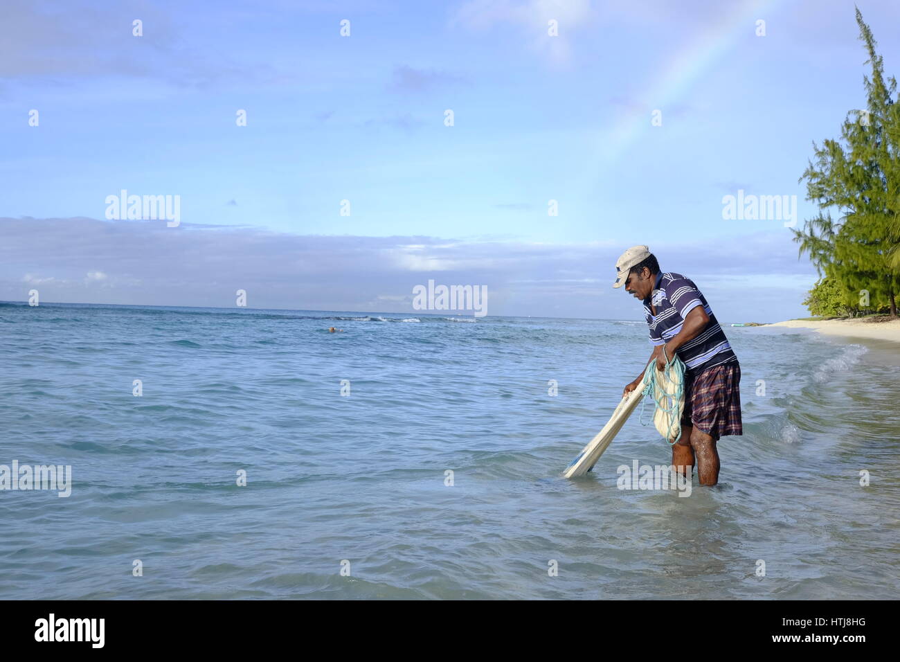 Fisherman casting his net in the sea, Hastings, Barbados, Caribbean Stock Photo