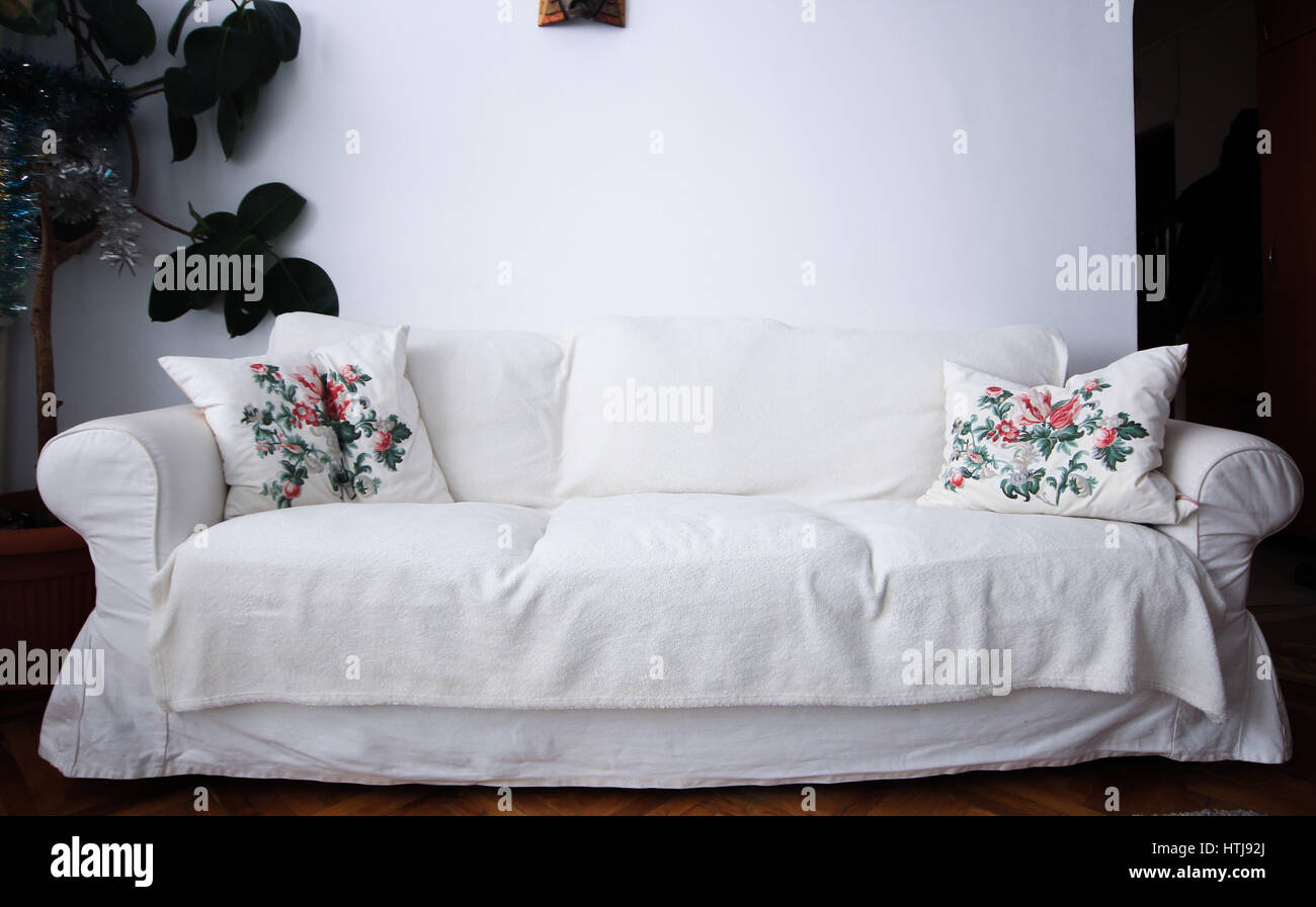 White living room couch with pillows and plant Stock Photo