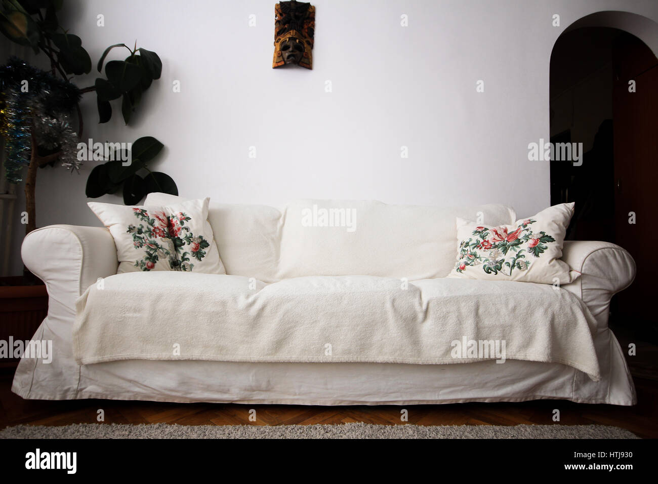 White living room couch with pillows and plant Stock Photo