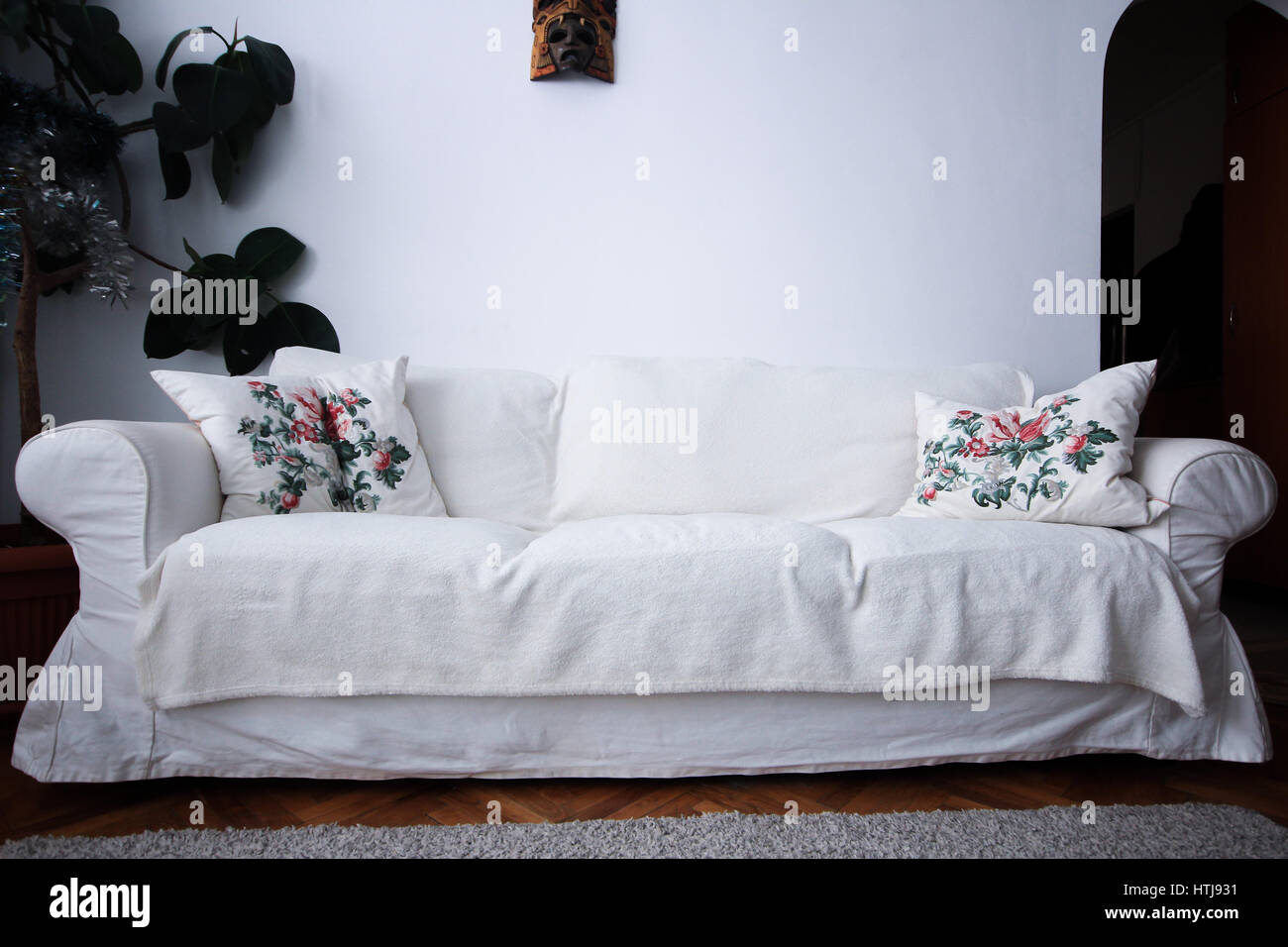 White living room couch with pillows and plant Stock Photo