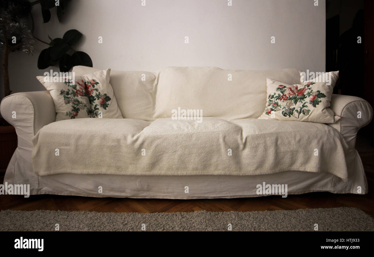White living room couch with pillows and plant Stock Photo