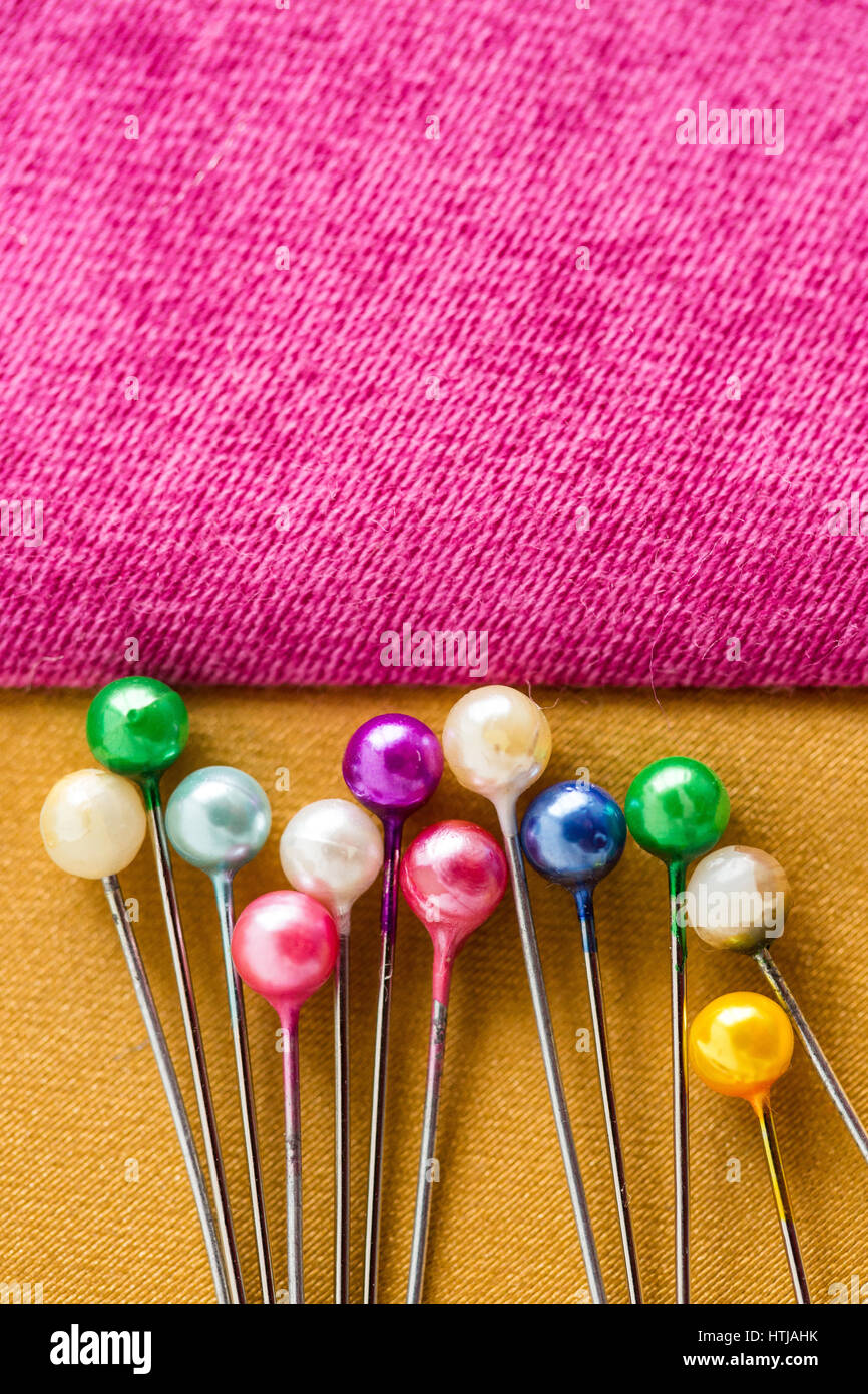 concept of color pins for sewing on pink and orange fabric close up with a  blank space for the text, macro. set of the tailor for sewing Stock Photo -  Alamy