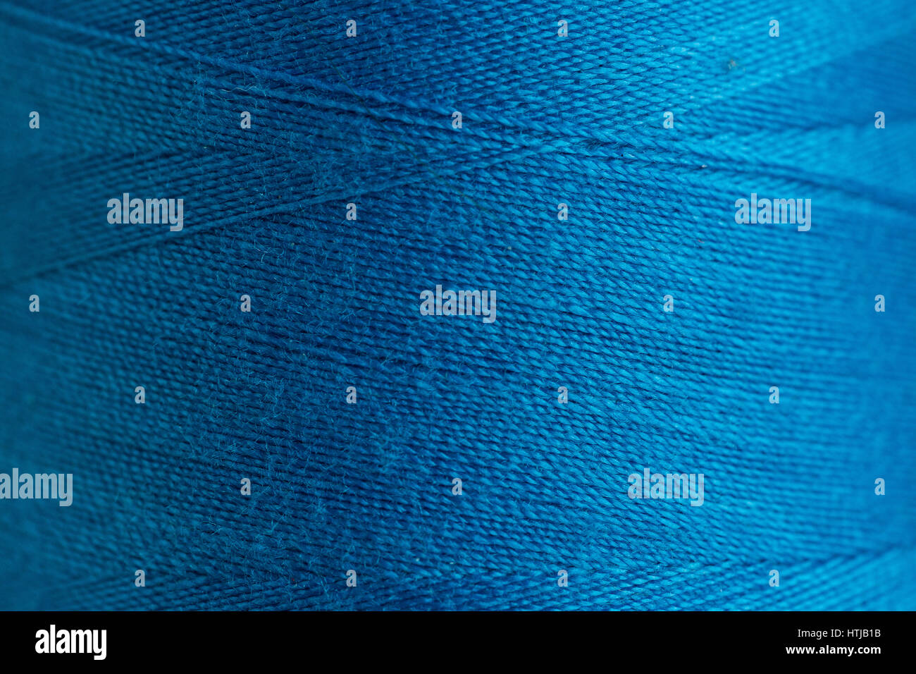 concept of the blue bobbin of thread close up, macro. sewing background ...
