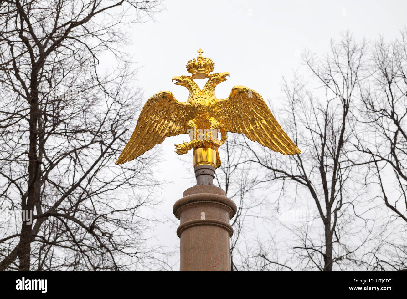 Golden Double Eagle mounted on stone column, Russian Federation coat of arms Stock Photo