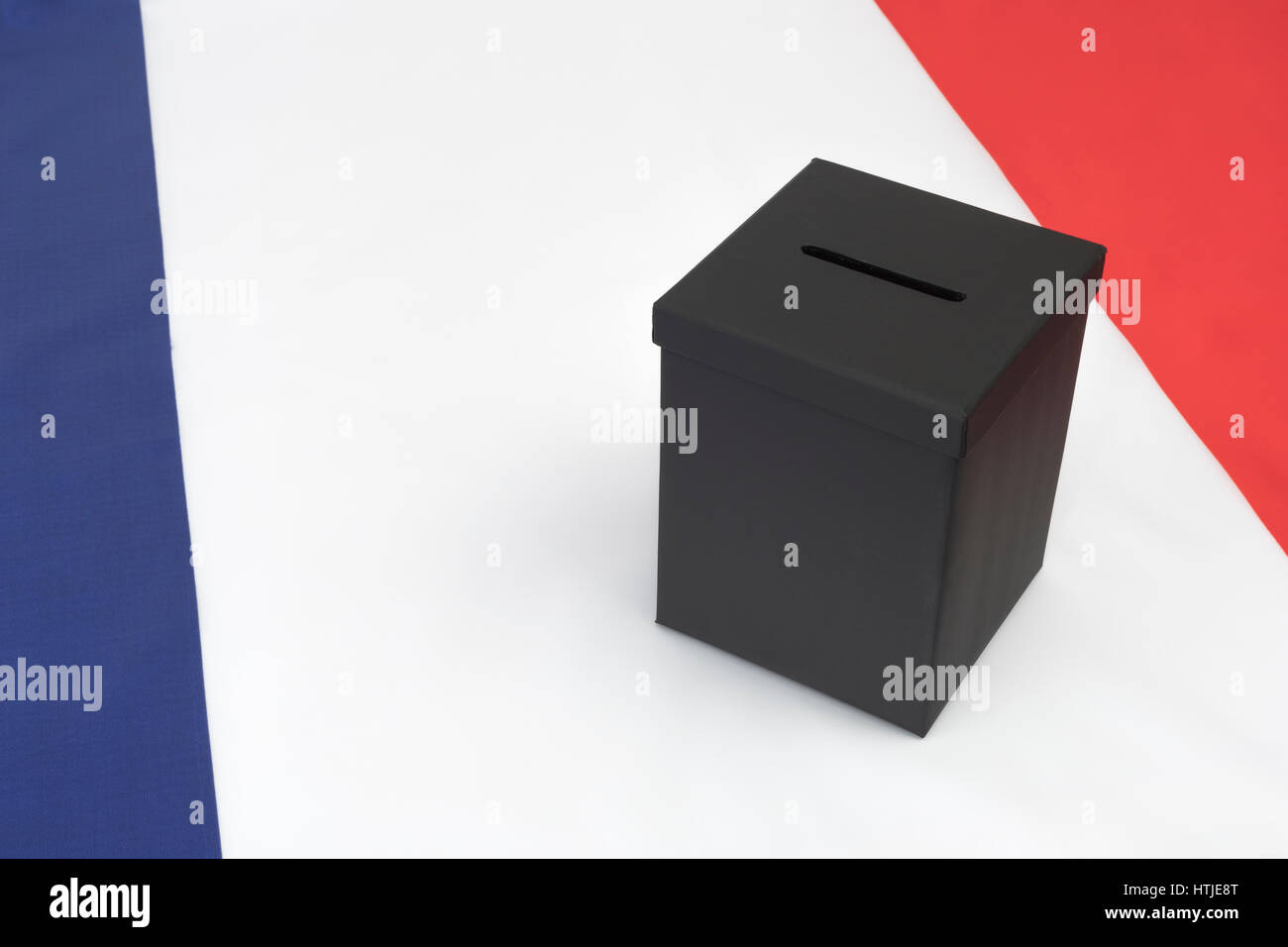 Small black box on French tricolor flag - as visual metaphor for the French Election. Stock Photo