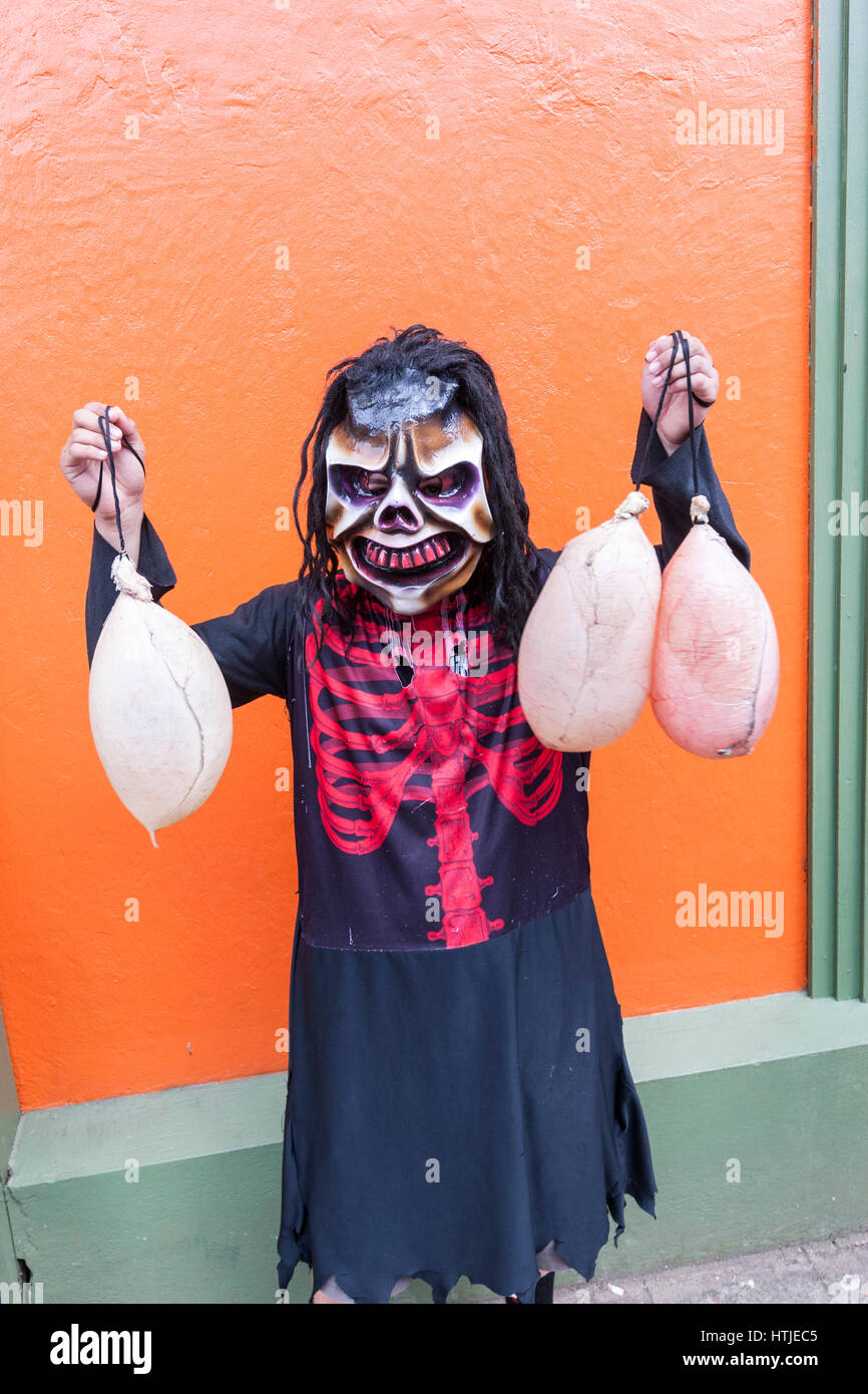 Local with mask and three cow bladder in a typical Masquerade fiesta with masks and cow bladder in  Barva, Heredia, Costa Rica Stock Photo
