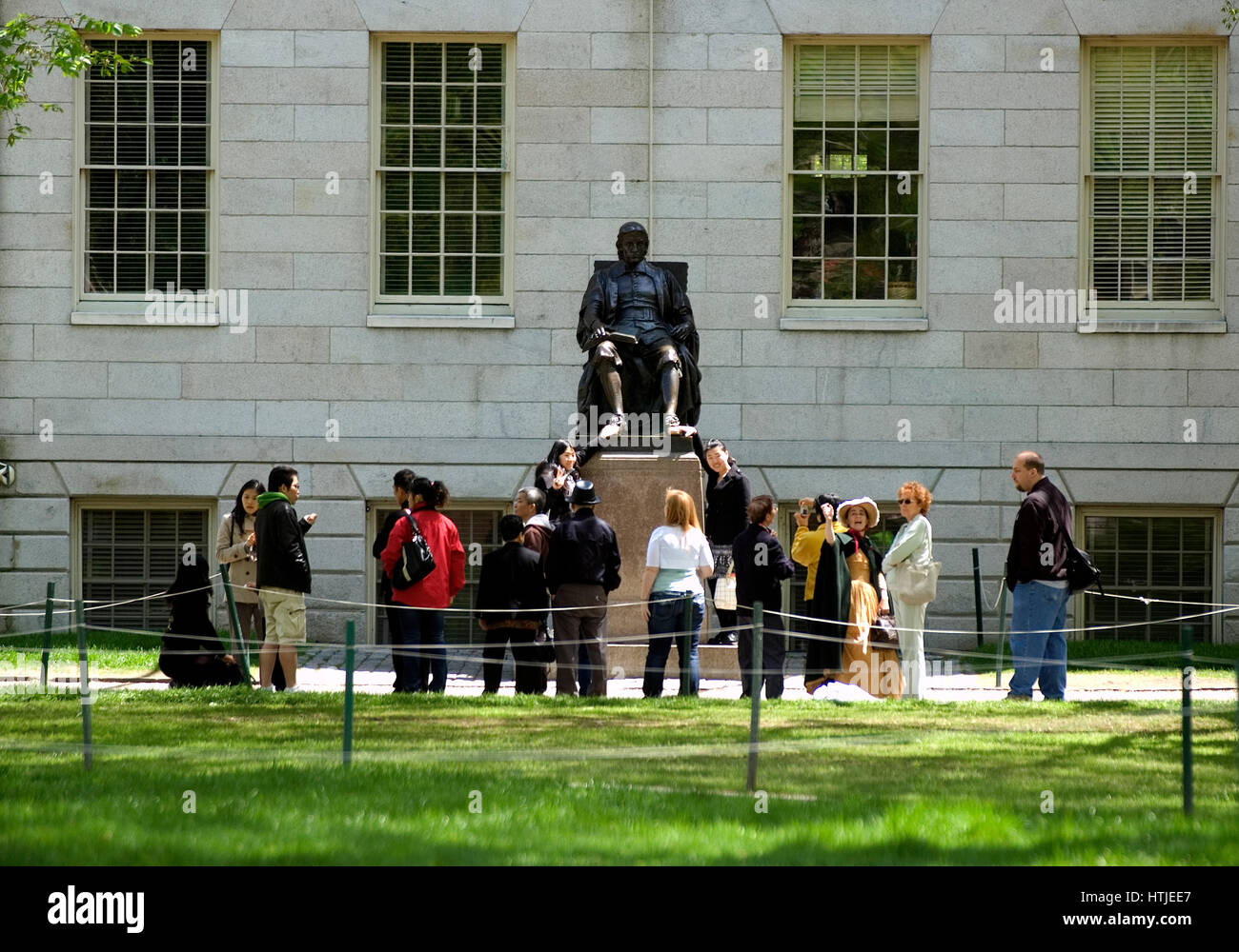 Harvard University - A gathering around the statue of John Harvard in Harvard Yard. Stock Photo