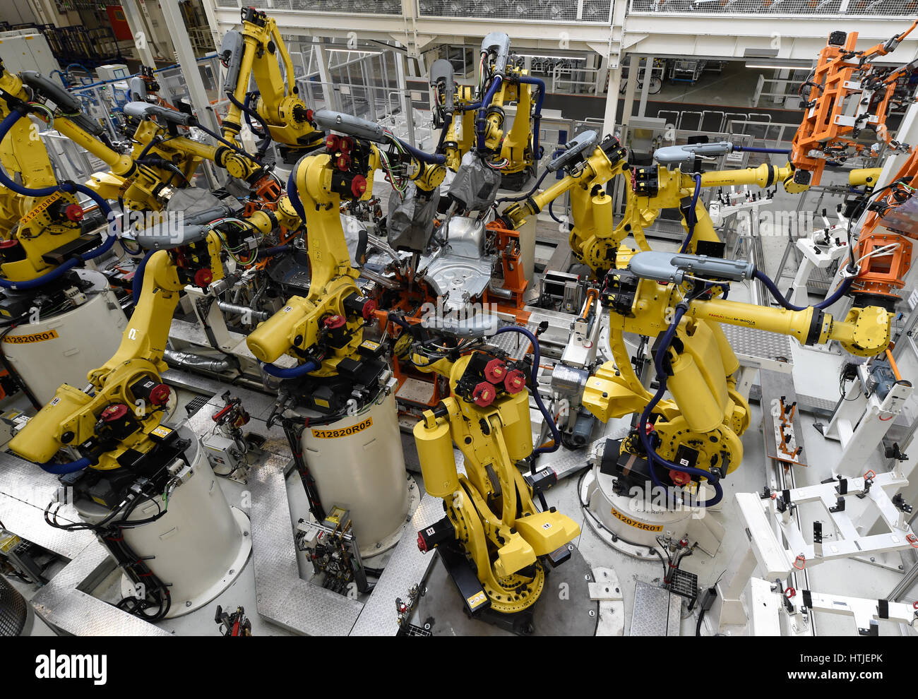 Welding robots surround Volkswagen Golf cars in a production line at the companies headquarter in Wolfsburg, March 9, 2017. Schweiss Roboter fertigen  Stock Photo