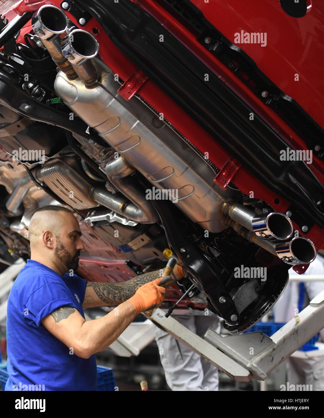 Exhaust systems of Volkswagen Golf cars are seen in a production line at the companies headquarter in Wolfsburg, March 9, 2017. Abgasanlage, Auspuff e Stock Photo