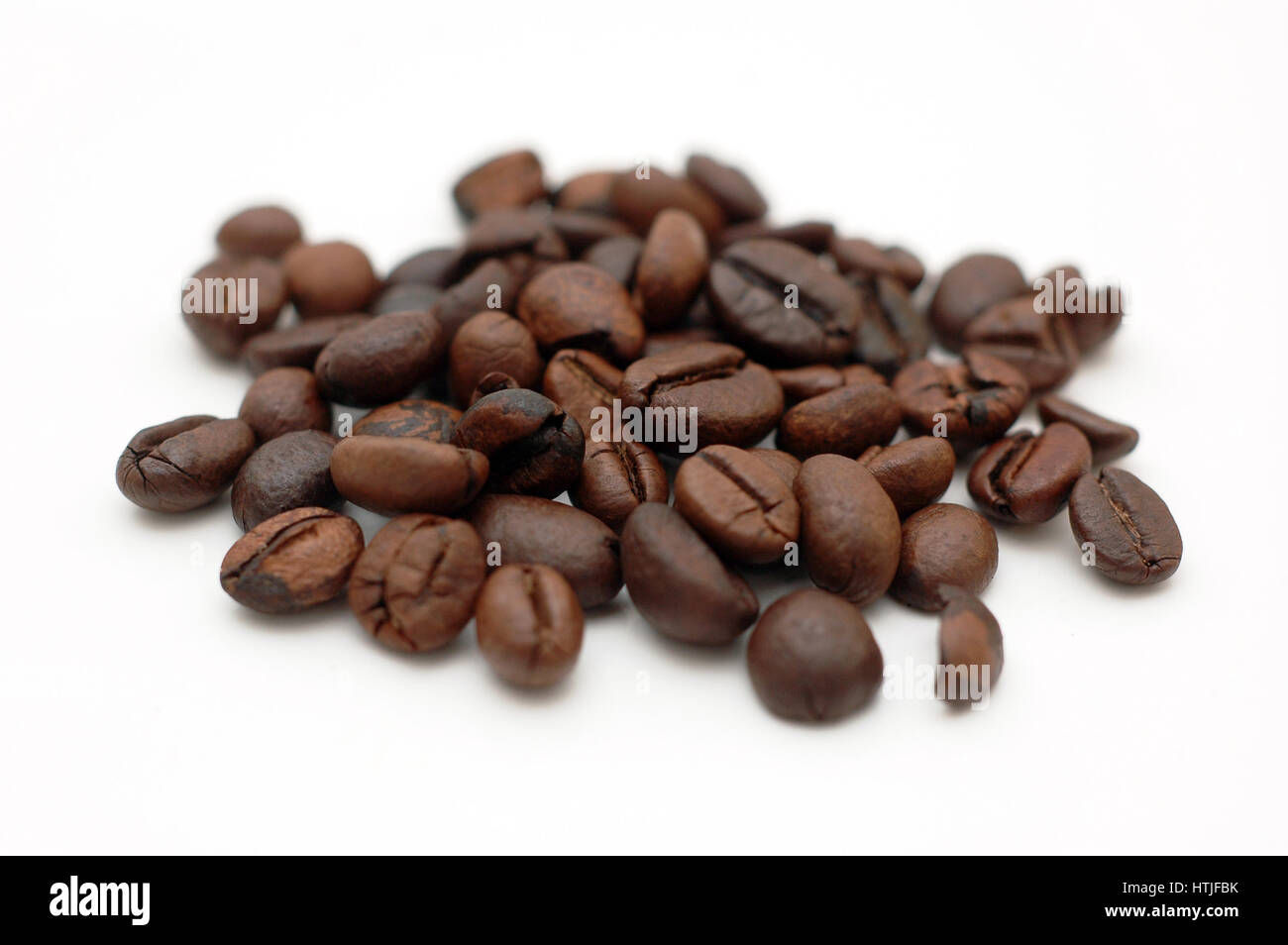 Macro on a small pile of coffee beans. Stock Photo