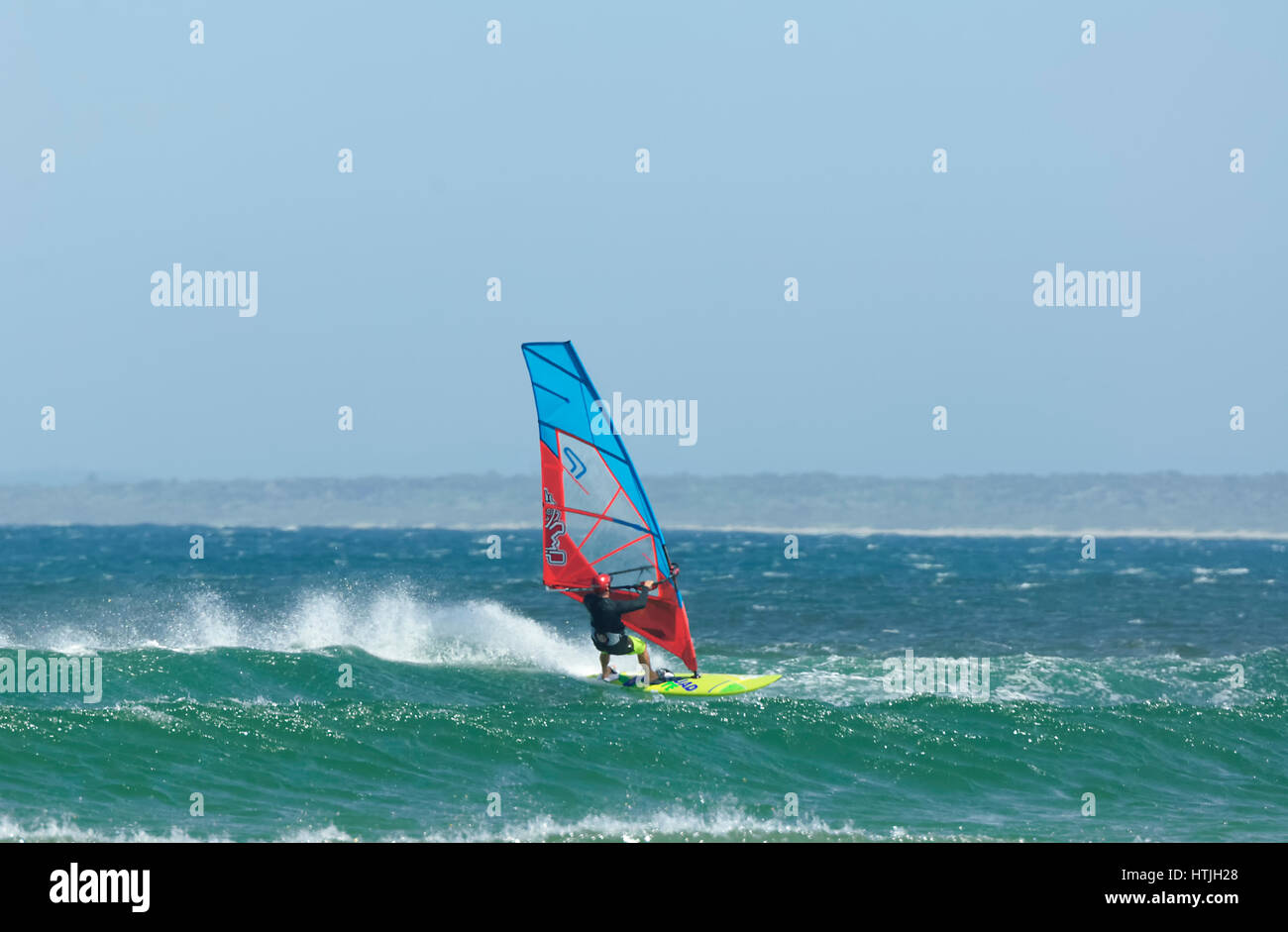 Windsurfer with colourful sails and surfboard at Seven Mile Beach