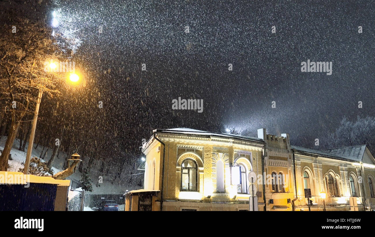 Snow blizzard in the night city. Christmas romantic mood weather Stock Photo