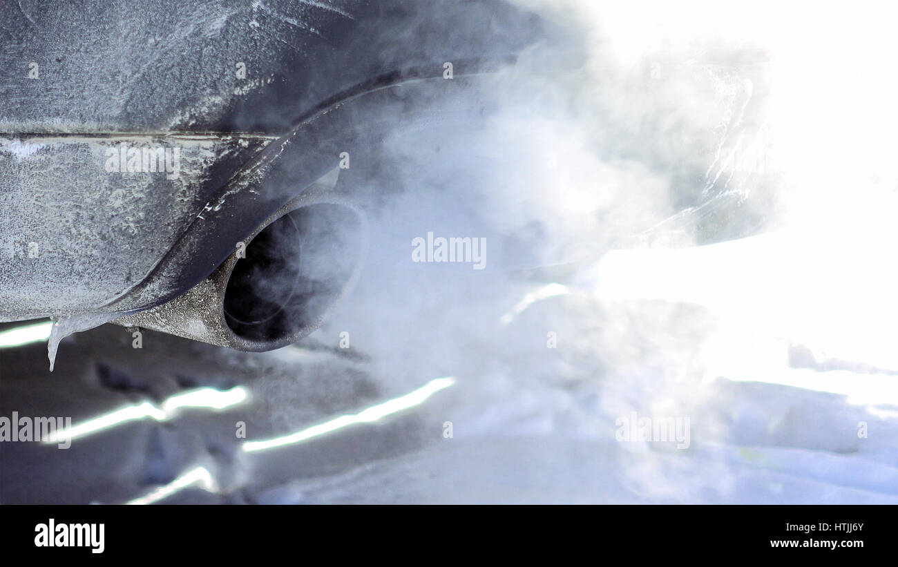 Car pipe puffs out exhaust gas clouds. Smoke clouds coming out of