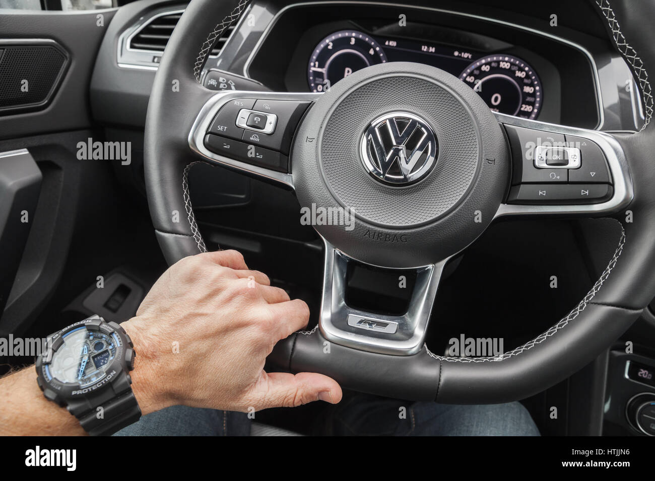 Hamburg, Germany - February 10, 2017: Volkswagen Tiguan, 4x4 R-Line. Black  compact luxury crossover vehicle interior. Driver hand with wrist watch on  Stock Photo - Alamy