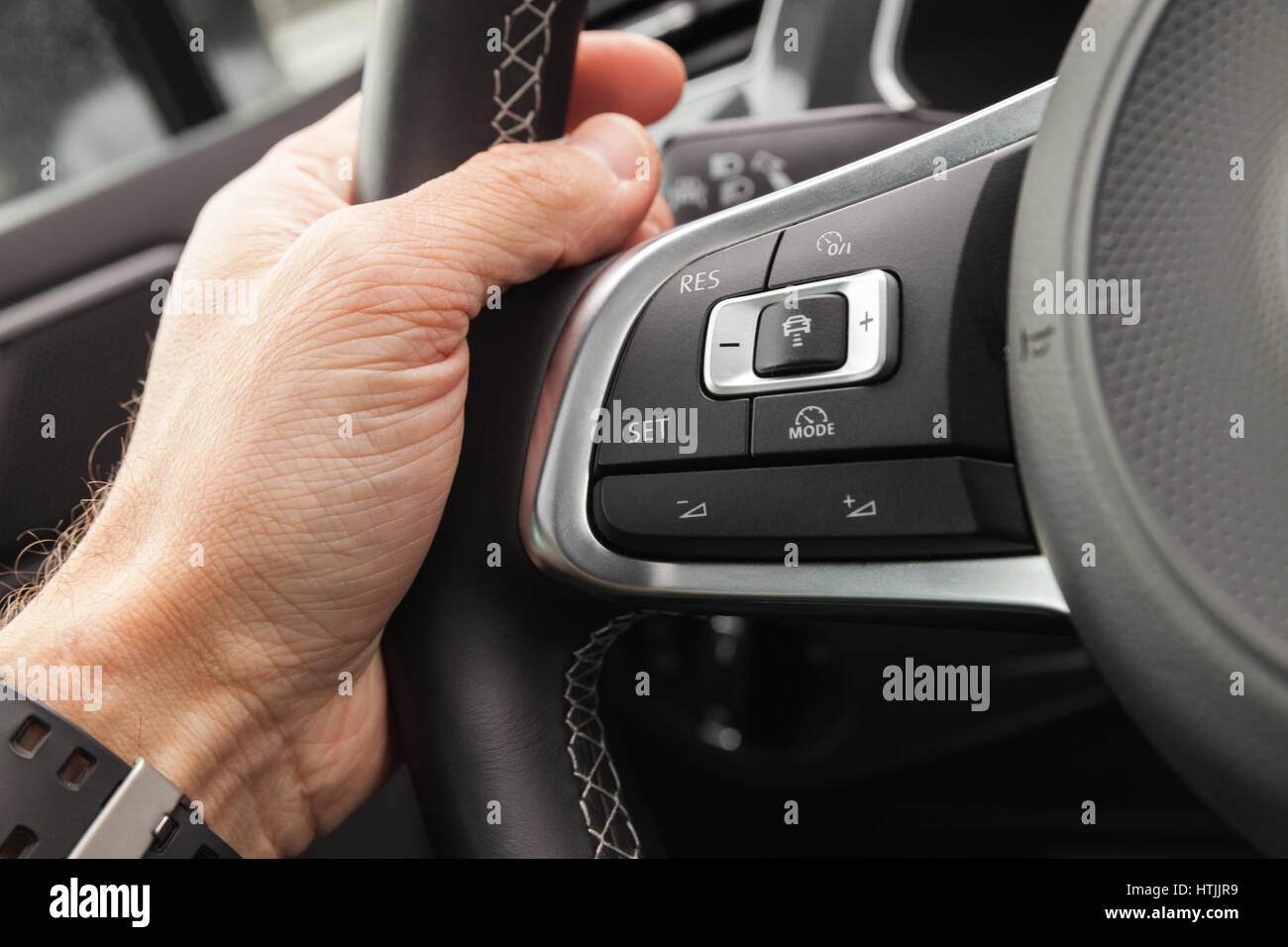 Adaptive cruise control panel buttons on modern car steering wheel
