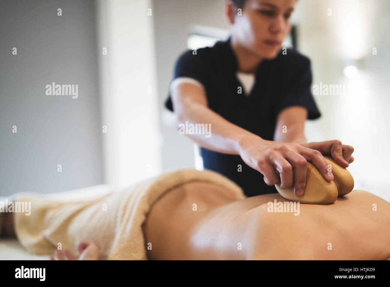 Cliend enjoying massage treatment given by masseur Stock Photo