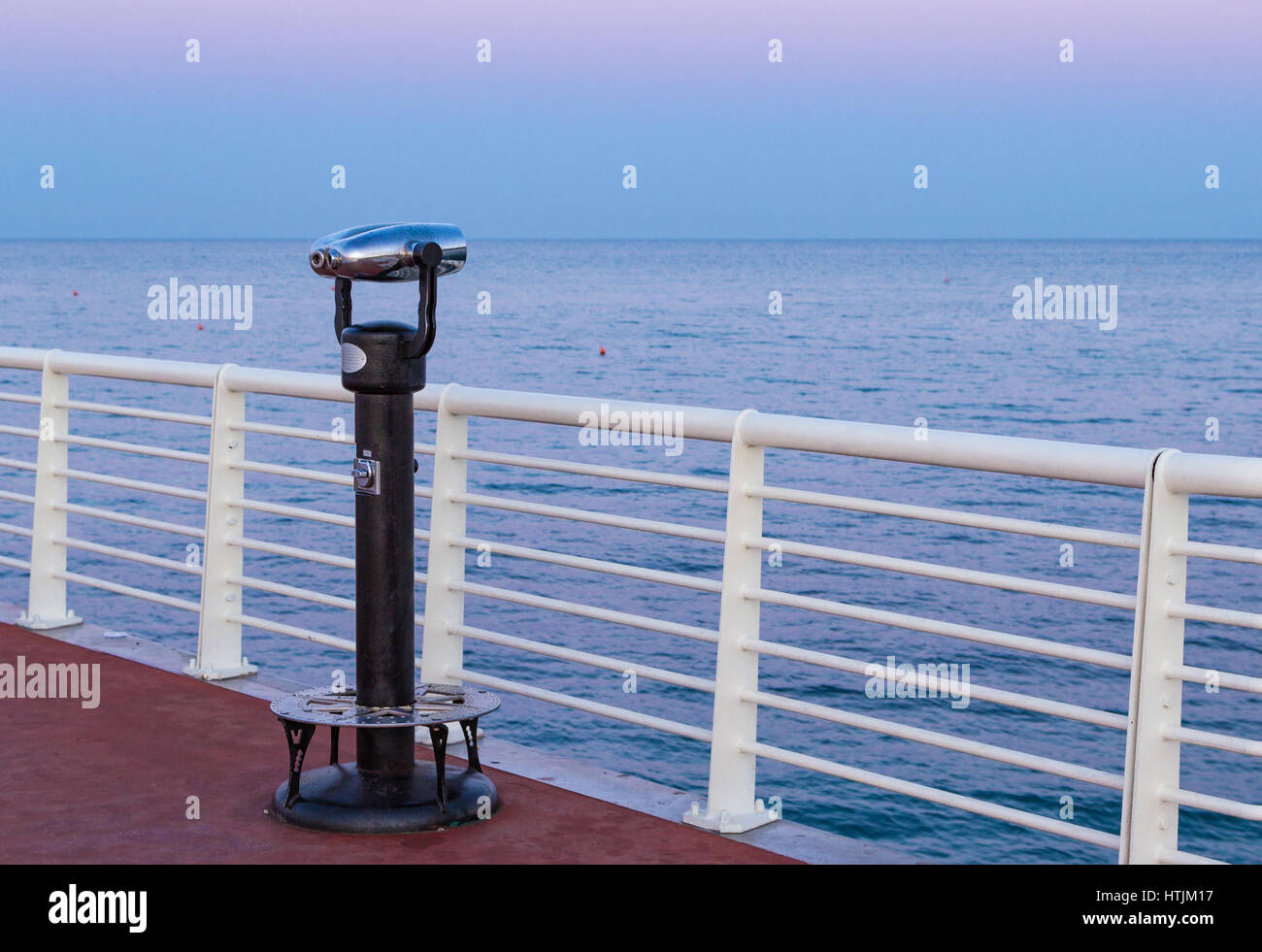 coin operated binoculars on a pier overlooking the sea Stock Photo