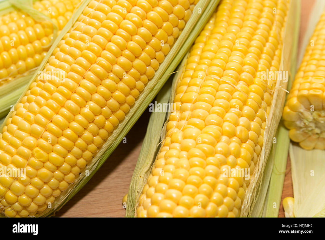 The fruits of ripe yellow corn are on the table Stock Photo