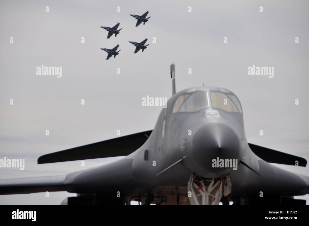 A USAF B-1B Lancer strategic bomber jet aircraft on display while four Royal Australian Air Force F-18 fighter jets practice flying in for an upcoming performance the Avalon