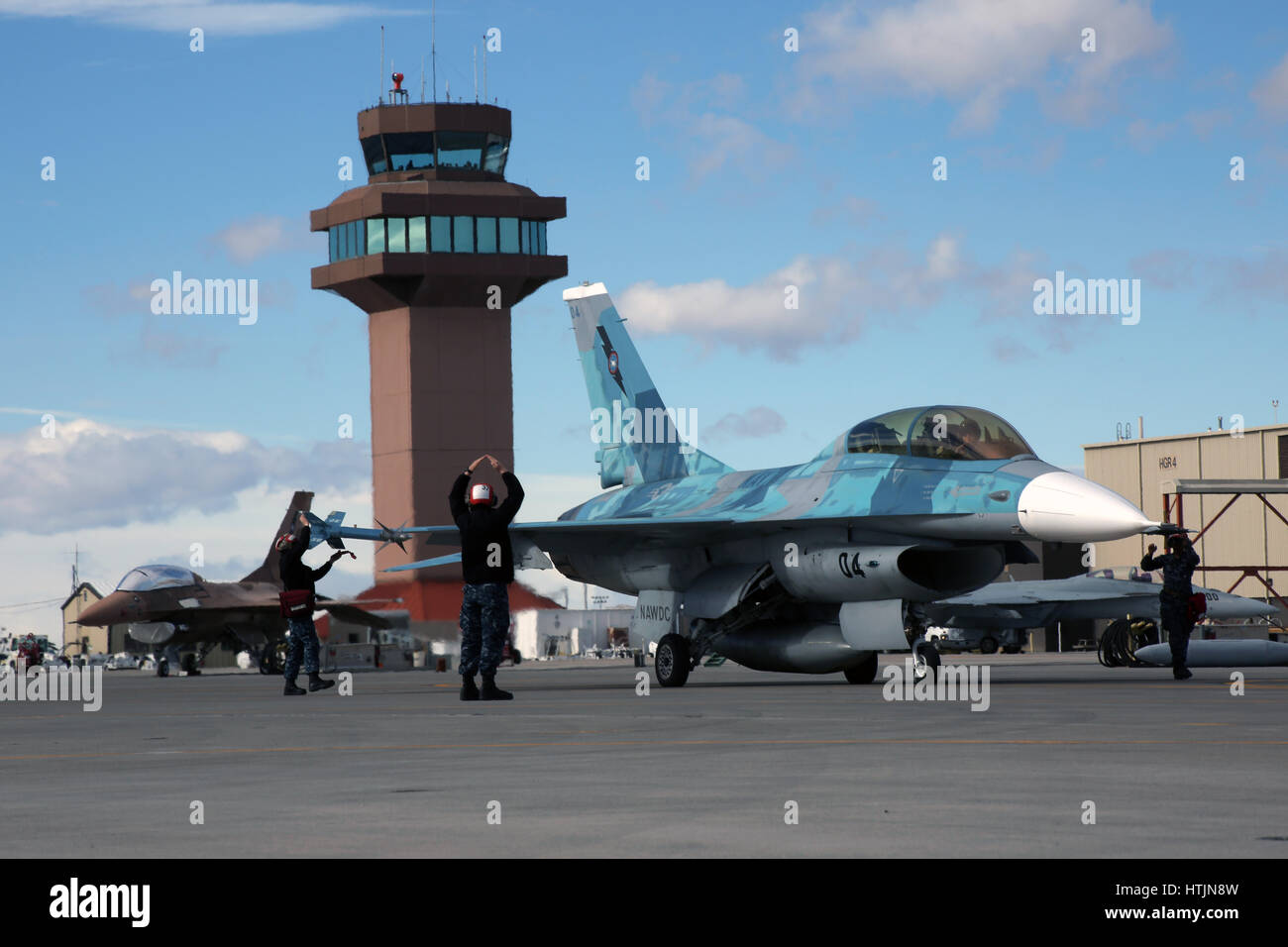 U.S. Navy ground crews signal a Air Force F-16V Fighting Falcon Viper fighter aircraft to taxi for take off at the Naval Air Station Fallon February 6, 2017 in Fallon, Nevada.        (photo by MCS1 Joseph R. Vincent /US Navy  via Planetpix) Stock Photo