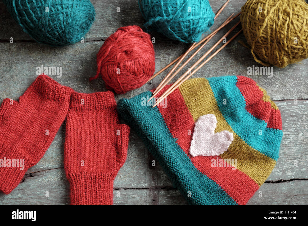 Handmade gift for winter, knitted gloves and knit hat for cold day, group of colorful yarn make warm, knit accessories is hobby activity of woman Stock Photo