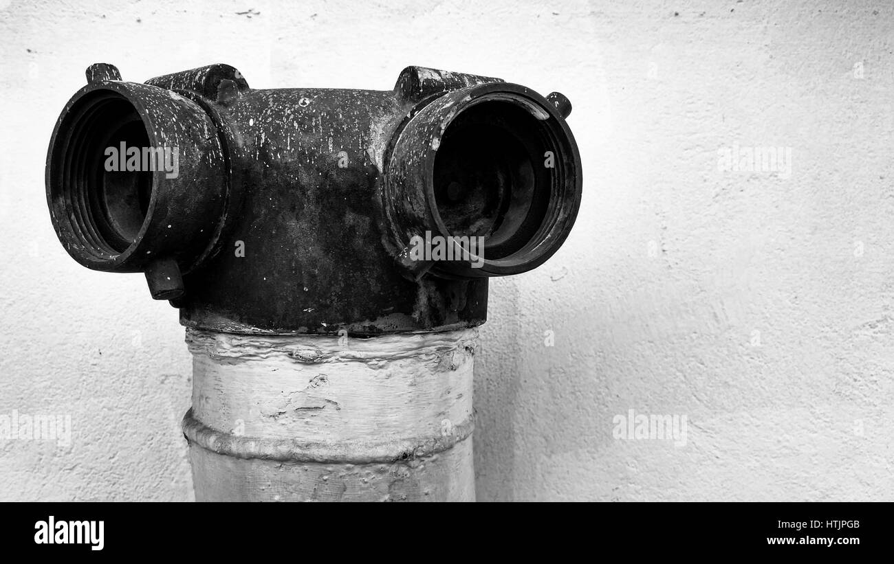 Old vintage fire department connection and rust stains in black and white tone, selective focus. Stock Photo