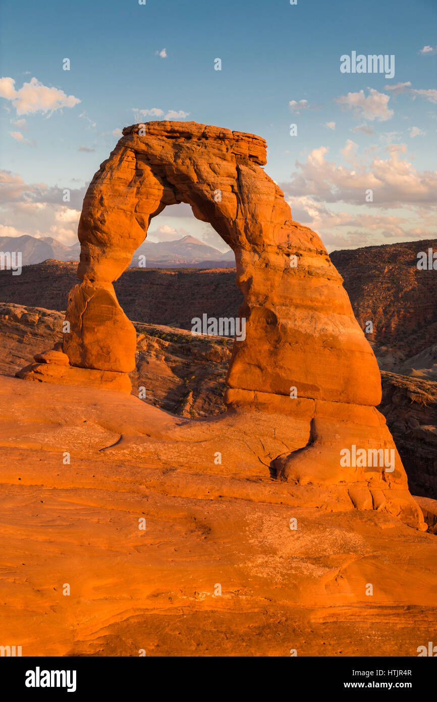 Classic postcard view of famous Delicate Arch, symbol of Utah and a popular scenic tourist attraction, in beautiful golden evening light at sunset in  Stock Photo
