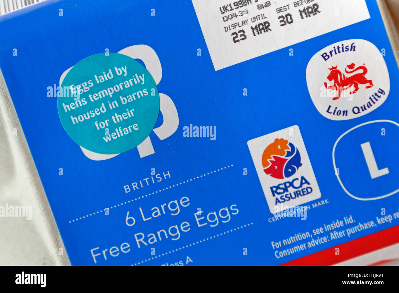 Sticker on an egg box stating 'Eggs laid by hens temporarily housed in barns for their welfare' as a measure to control the spread of Avian Flu in UK. Stock Photo