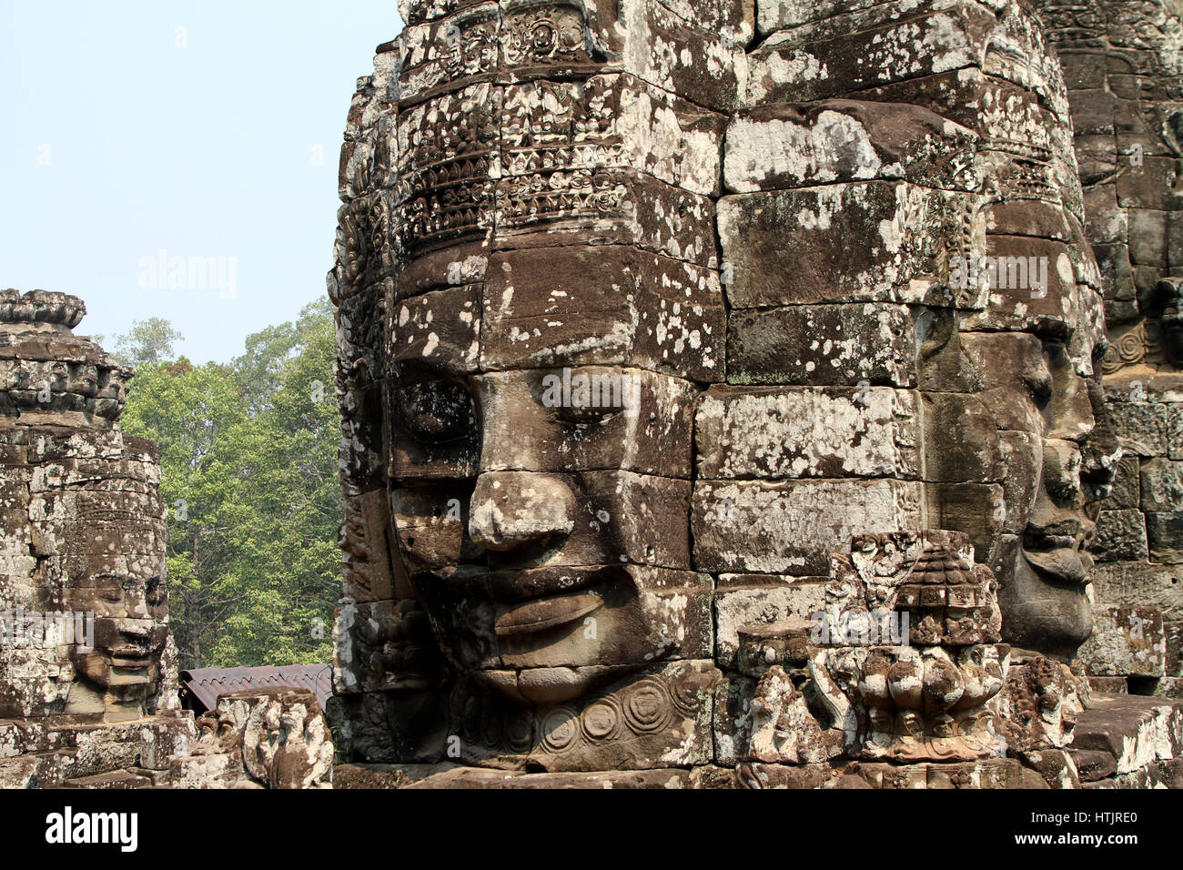 The iconic smiling faces of the Bayon temple in Angkor Thom, the former capital of the Khmer empire outside modern-day Siem Reap, Cambodia. Stock Photo