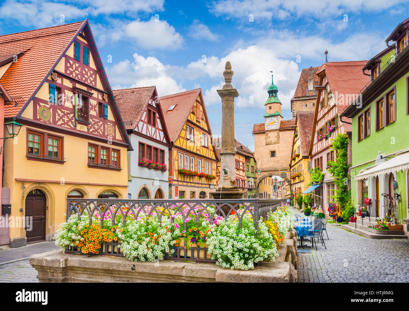 Beautiful postcard view of the famous historic town of Rothenburg ob der Tauber on a sunny day with blue sky and clouds in summer, Franconia, Bavaria, Stock Photo