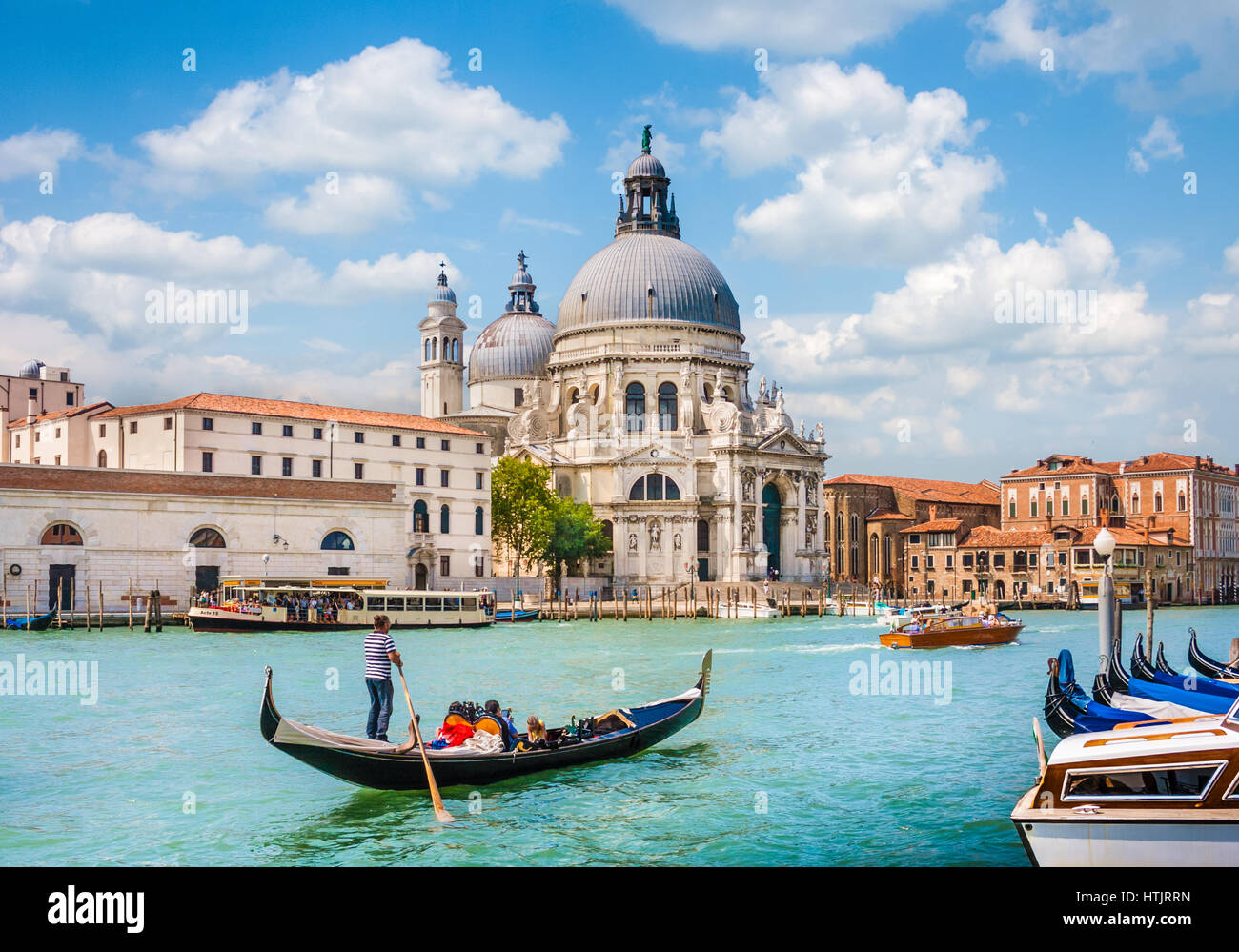 Traditional Gondola on Canal Grande with Basilica di Santa Maria della Salute in the background, Venice, Italy Stock Photo
