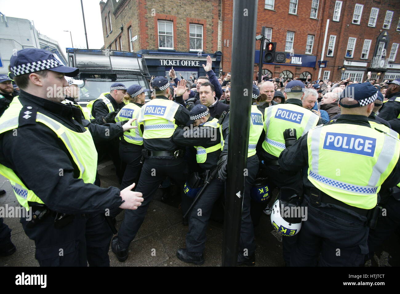 Football fans face police prior to the Tottenham Hotspur v Millwall, Emirates FA Cup quarter final game at White Hart Lane, Tottenham. Stock Photo