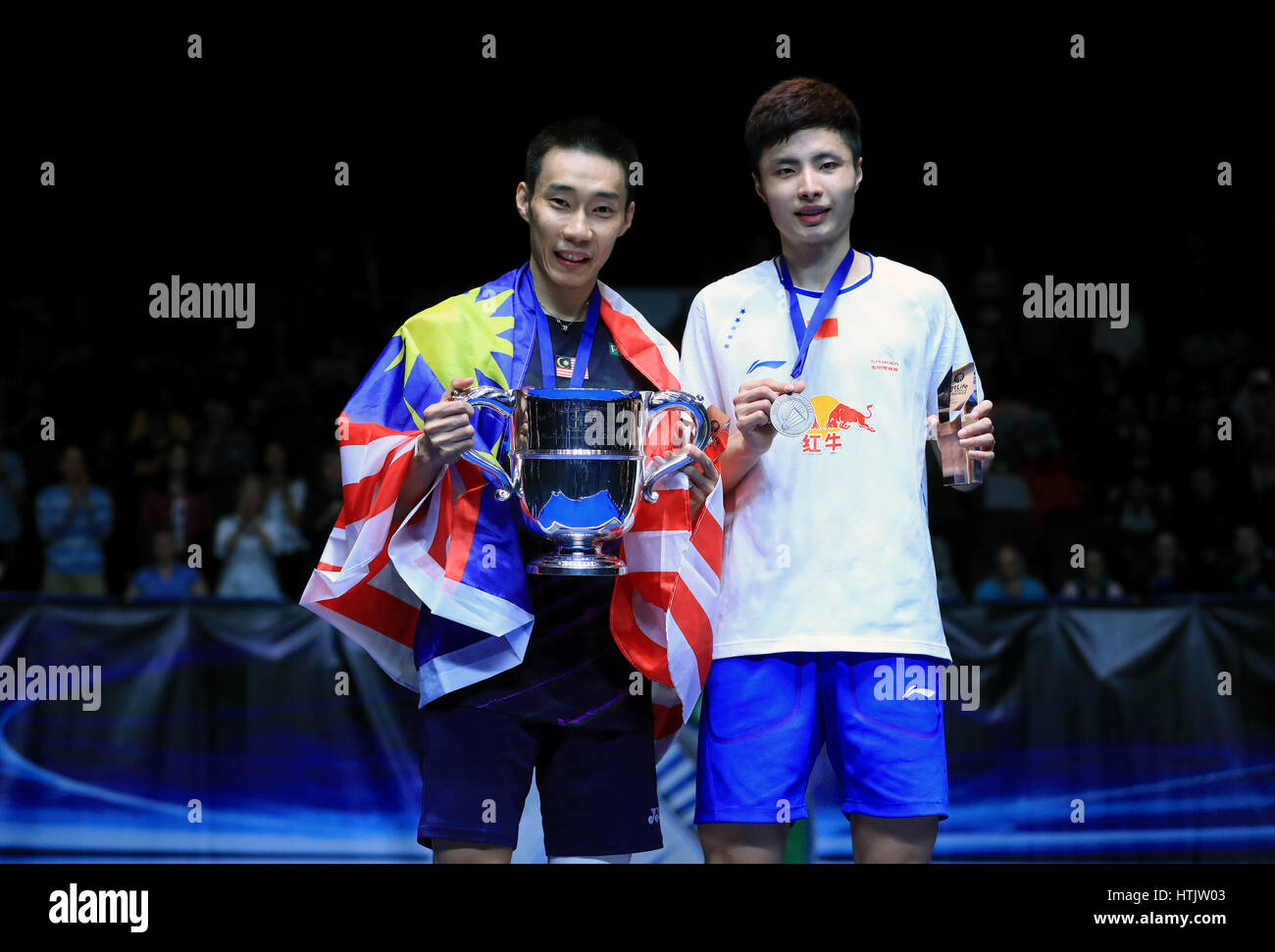 Malaysia's Chong Wei Lee (left) celebrates victory over China's Yuqi Shi on the podium in the Men's Singles Final during day six of the YONEX All England Open Badminton Championships at the Barclaycard Arena, Birmingham. Stock Photo