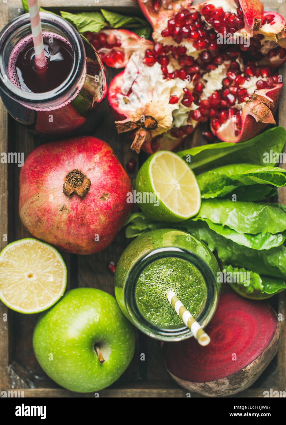 Closeup of green and purple fresh juices with fruits, vegetables Stock