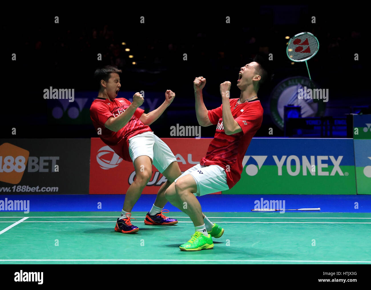 Indonesia's Marcus Fernaldi and Kevin Sanjaya celebrate victory over China's Li Junhui and Liu Yuchen in the Men's Doubles Final during day six of the YONEX All England Open Badminton Championships at the Barclaycard Arena, Birmingham. Stock Photo