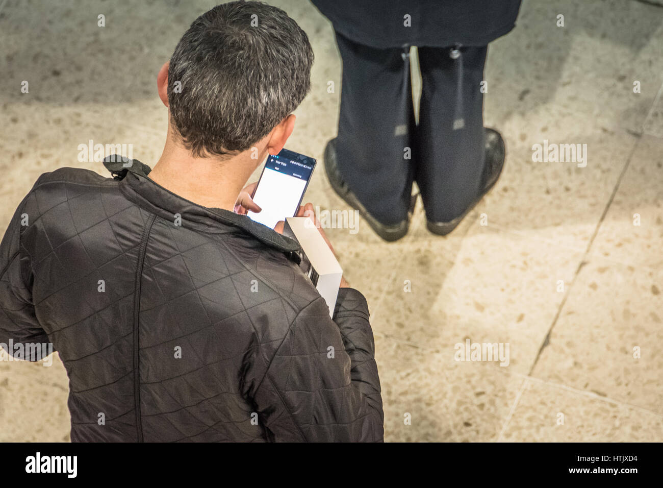 Men constantly checking their mobile phones Stock Photo
